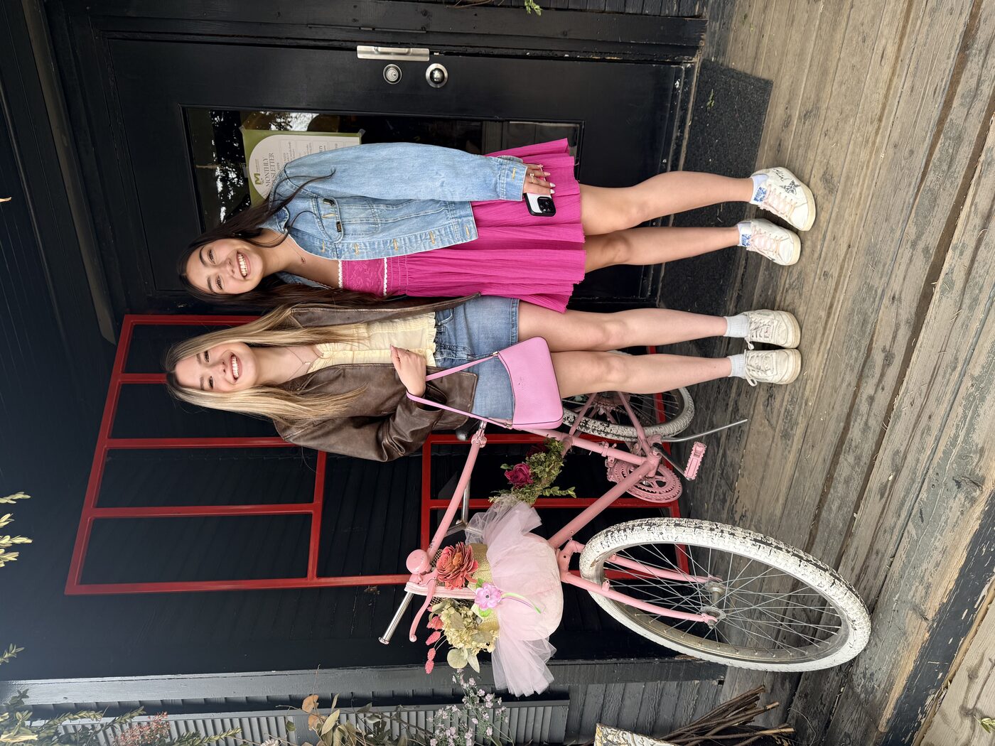 Tess and Alona by the pink bike