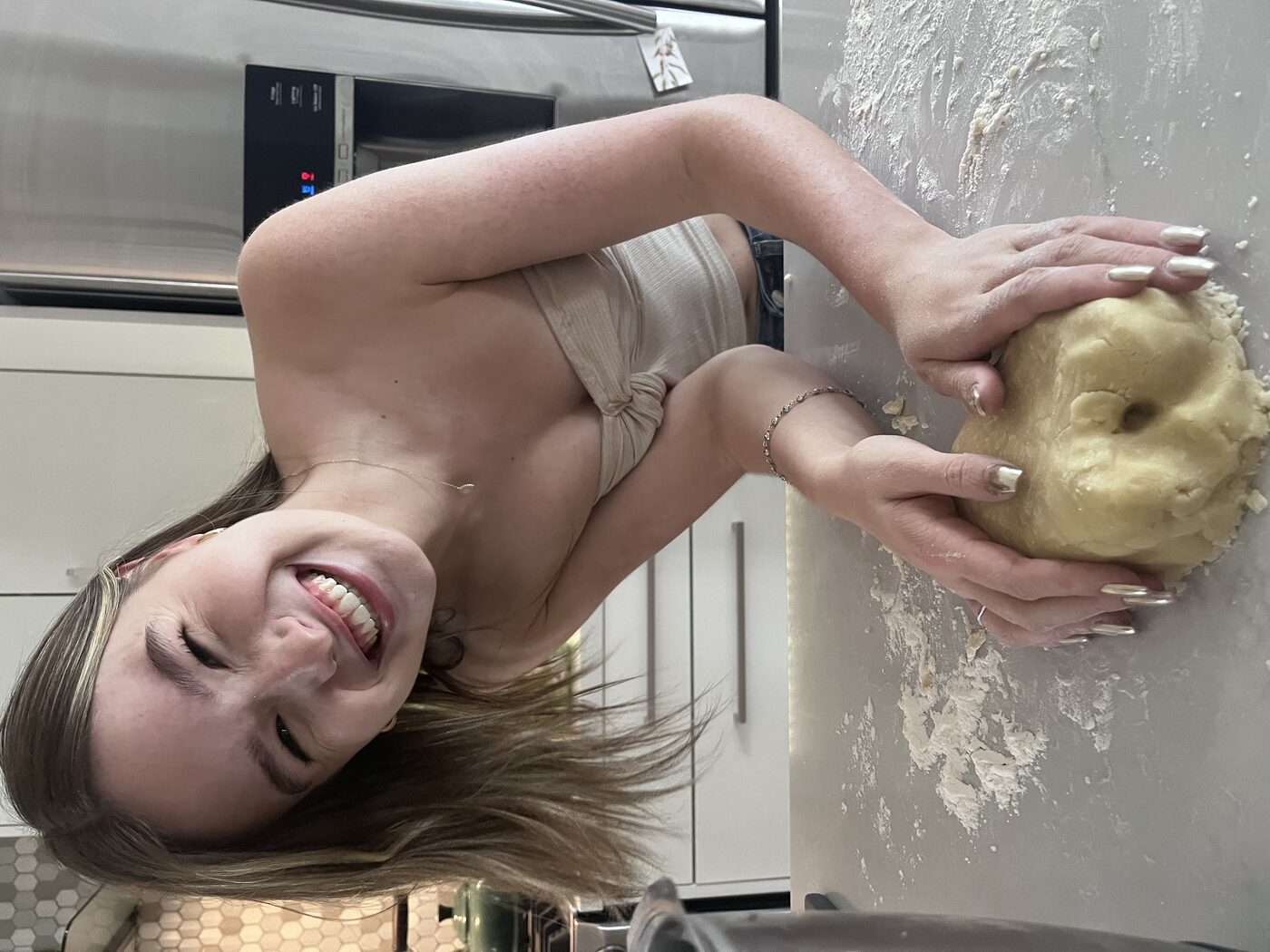 Tess laughing while baking